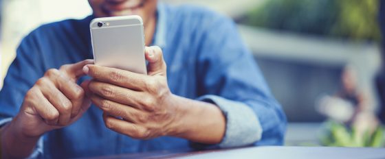  | close up  hand hold mobile cell phone device:focus on man play o